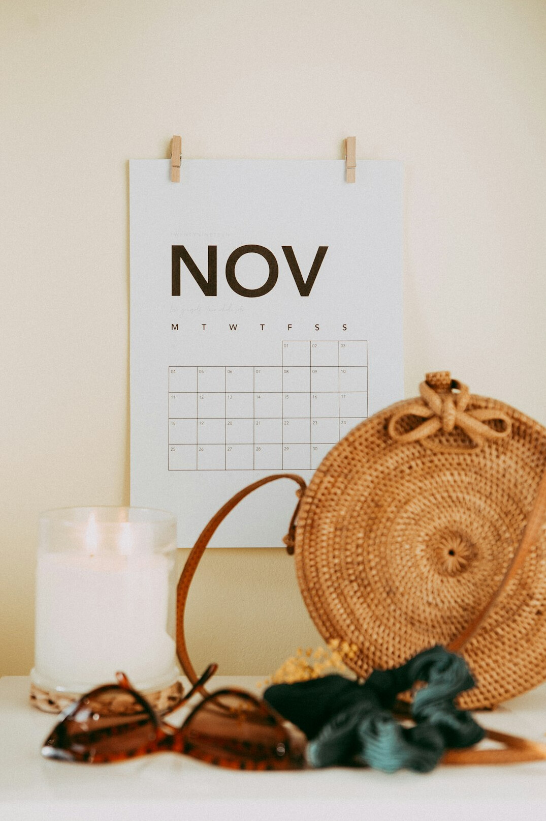 Wall calendar, reading glasses and planning documents on a table