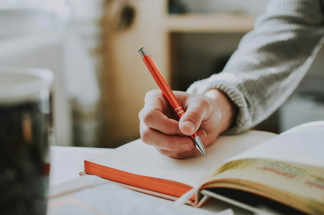 woman writing in notebook